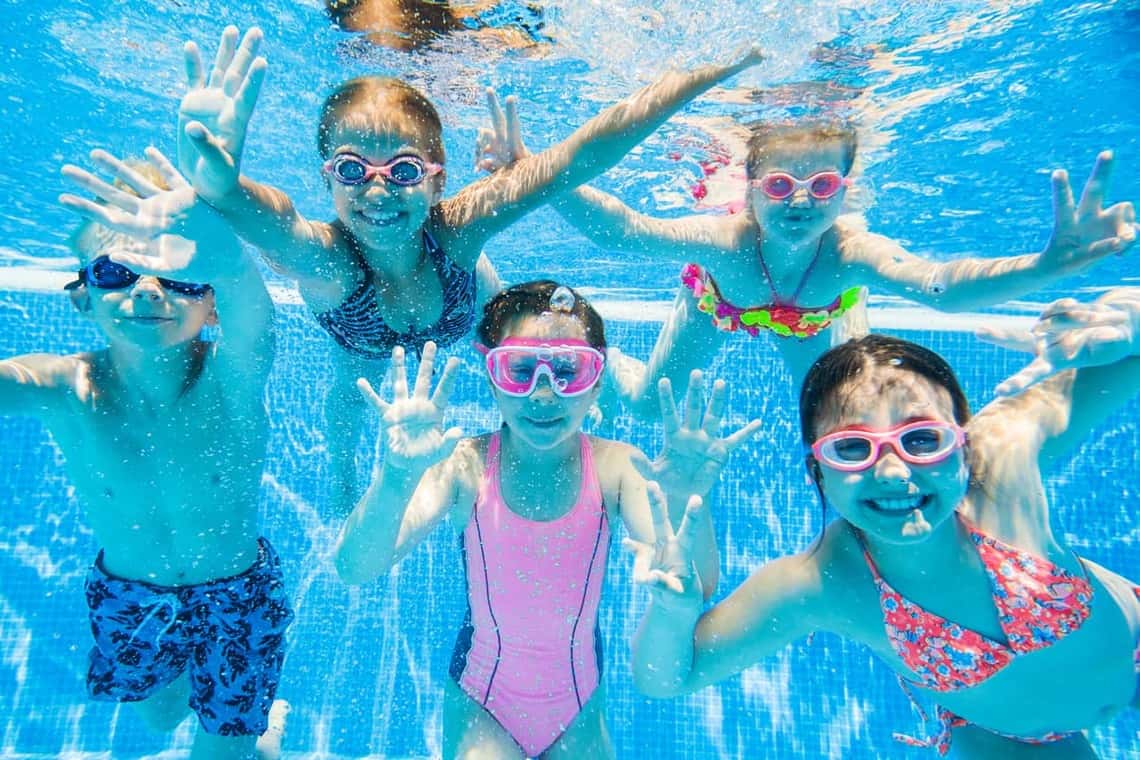 Happy kids playing underwater